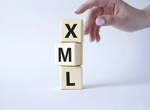 XML - Extensible Markup Language. Wooden cubes with word XML. Businessman h.. Foto stock