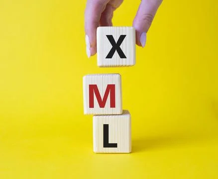 XML - Extensible Markup Language. Wooden cubes with word XML. Businessman h.. 库存照片