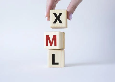 XML - Extensible Markup Language. Wooden cubes with word XML. Businessman h.. Foto stock
