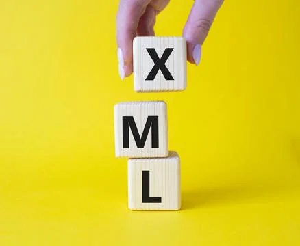 XML - Extensible Markup Language. Wooden cubes with word XML. Businessman h.. Foto stock