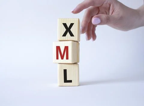 XML - Extensible Markup Language. Wooden cubes with word XML. Businessman h.. 스톡 사진