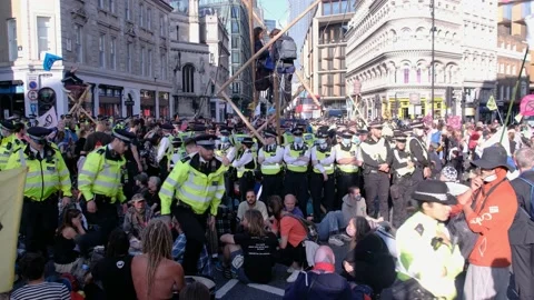 XR Protesters Block St &amp; erect bamboo structure while being surrounded by Police Stock Footage 160151270