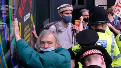 XR Protesters glue hands to wall and surrounded by Police at Blood Money Protest Stock Footage 160151151