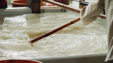 Xuan Paper Making - Mixing Pulp in Vat 4K Stock Footage 339084033