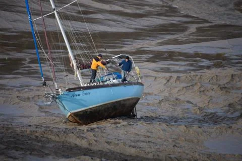Yacht beached on mud Stock Photos