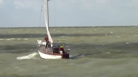 Yacht leaves the port in storm in Stavoren (IJsselmeer in Holland) Stock Footage