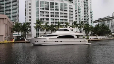 Yacht passing through Miami river in front of big buildings Stock Footage 248477326