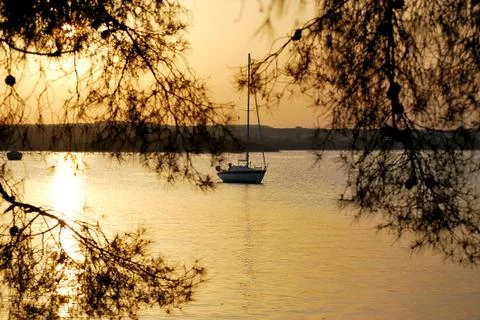 Yacht in the rays of the setting sun 스톡 사진