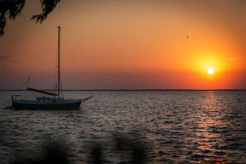 Yacht in the rays of the setting sun. Stock Photos