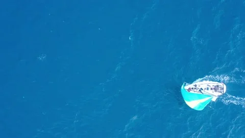 A yacht with a sail crosses the frame Stock Footage 168053653