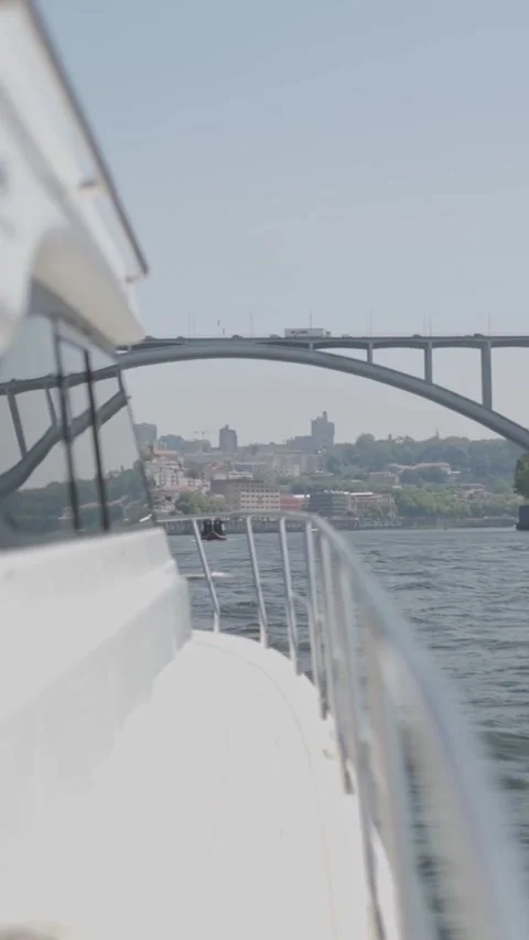Yacht sailing on douro river passing under arrabida bridge in porto Stock Footage 327806008