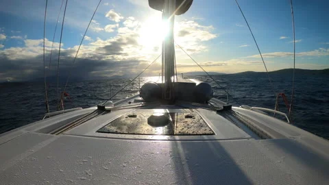 Yacht sailing at sunset during a storm. Luxury vacation at sea Vidéo 147643342