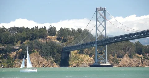 Yacht Sailing Under Bay Bridge, San Francisco Bay, California Stock Footage