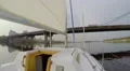 Yacht sailing under river city bridge, cityscape, pollution, POV HD Footage