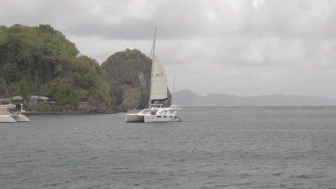 Yacht sails into harbor Stock Footage 107632845
