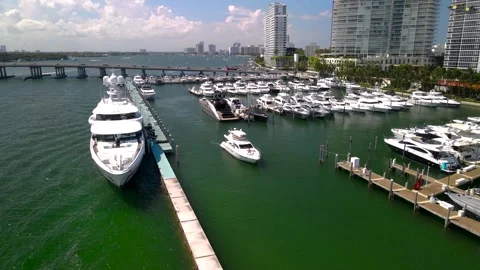 Yacht sails out of the harbor - Drone footage of Miami Beach Marina 4k Stock Footage 244002282