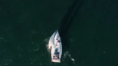 Yacht with white sails floating on the waves in the sun from sunset Stock Footage 198335717