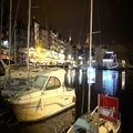 Yachts and boats moored to shore in city harbor at night, illuminated embankment 4k or 4k+ Resolution