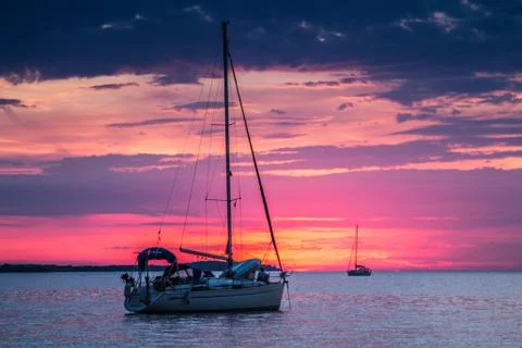 Yachts off the coast of Croatia at sunset Stock Photos