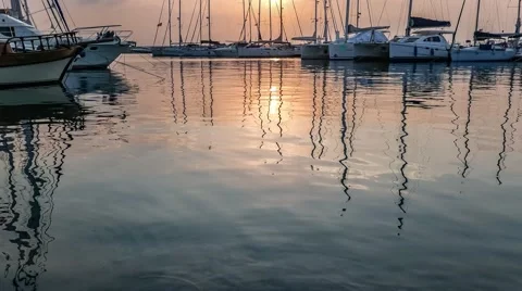 Yachts masts reflection in the sea water under the twilight Stock Footage