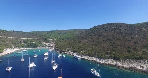 Yachts moored in beautiful bay - camera moves down Stock Footage 73237741