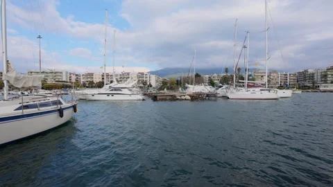 Yachts moored in marina with waves and stormy sky before rain Stock Footage 337458932