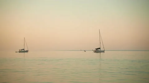 Yachts in the ocean at dawn Stock Footage 201165235