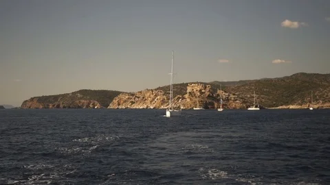 Yachts passing by the island Stock Footage 71054717