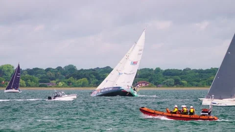 Yachts Passing Lifeboat under full sail 2025 Round the Island Race Isle of Wight Stock Footage 337936795