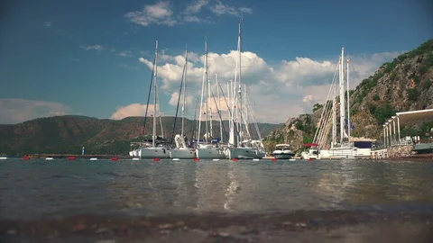 Yachts at the pier on the background of mountains	 Stock Footage 127945270