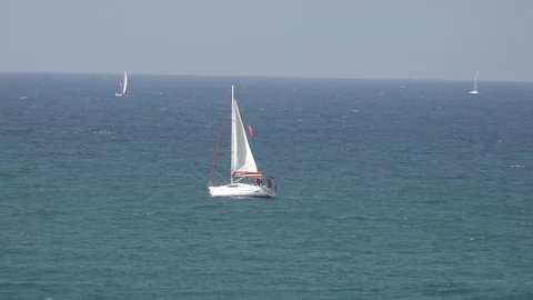Yachts in the see, one man going on the deck Stock Footage 100596701