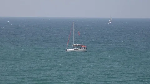 Yachts in the see, one man going on the deck Stock Footage 100597440