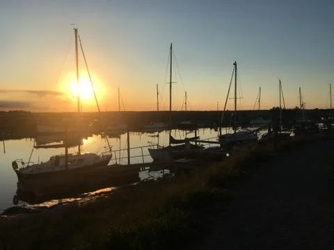 Yachts at sunset on river Фото