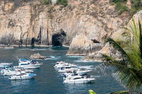 Yachts viewing La Quebrada cliff diving site in Acapulco Mexico under sun Stock Photos