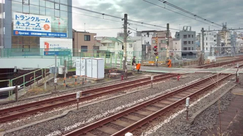 Yamanote line with a train passing over the level crossing of Komagome. Stock-Footage 165981099