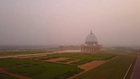 Yamoussoukro cathedral from above during harmattan fog,  Ivory Coast Stock-Footage 128744971