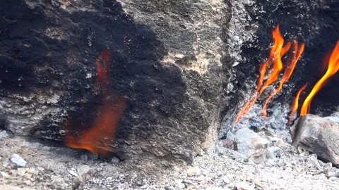 Yanartas methane flames burn through rocky vent - Gas Source and Exposed Strata Stock Footage 339792124