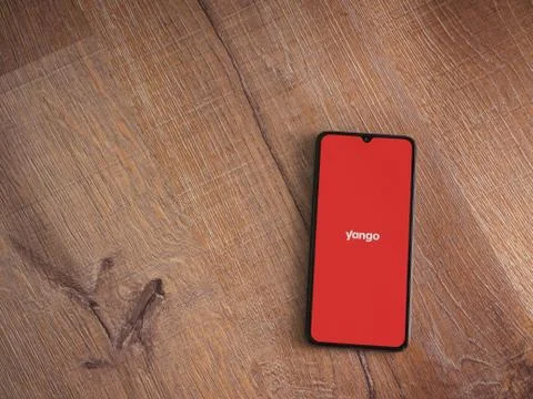 Yango Ride app launch screen with logo on the display of a black mobile smart Stock Photos