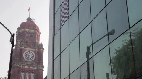 Yangon Clock Tower Courthouse With Glass Building In Foreground Stock Footage 56632082
