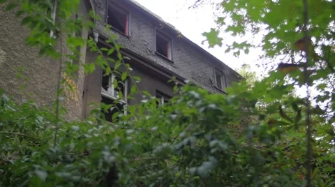Yard of an abandoned building with broken windows Video stock 58592554