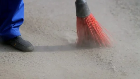 Yard cleaner sweeps the asphalt Stockbeeldmateriaal 74652611