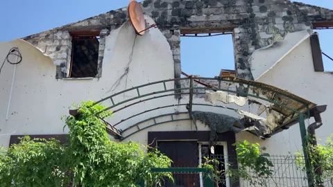 The yard of a private house in Irpen which was destroyed by the war Stock Footage 242990191