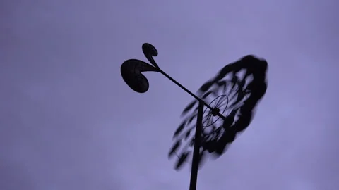 A yard spinner or weather-vane in shifting gusty winds Stock Footage 230089640