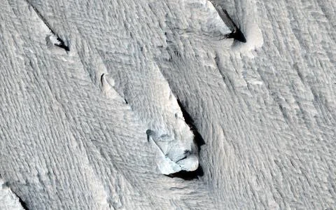 Yardangs are streamlined hills that are carved by wind erosion from bedroc... Stock Photos