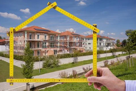 Yardstick folded in form of an house in hand of an agent yardstick folded ... Stock Photos