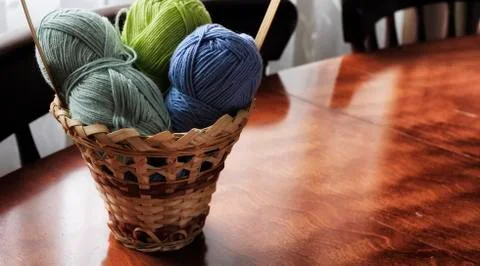 Yarn and knitting needles on the table in the room Stock Photos