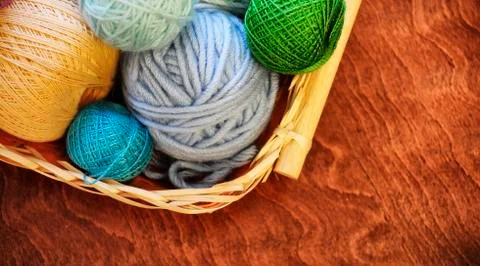 Yarn and knitting needles on the table in the room Stock Photos