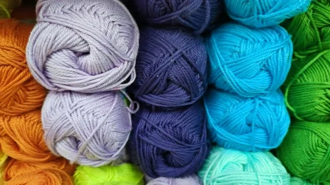Yarn of different colors. Knitting threads in the needlework store Видео 174250790
