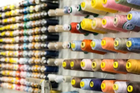 Yarn or thread of different colors on a wall Stock Photos