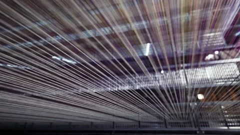 Yarn thread lines on the weaving loom machine in textile factory. Textile Stock Footage 204776458